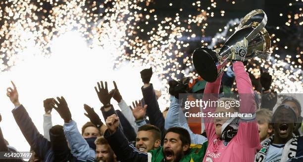 Jimmy Nielsen of Sporting KC celebrates with the Philip F. Anschutz trophy and his teammates after defeating Real Salt Lake in penalty kicks to win...