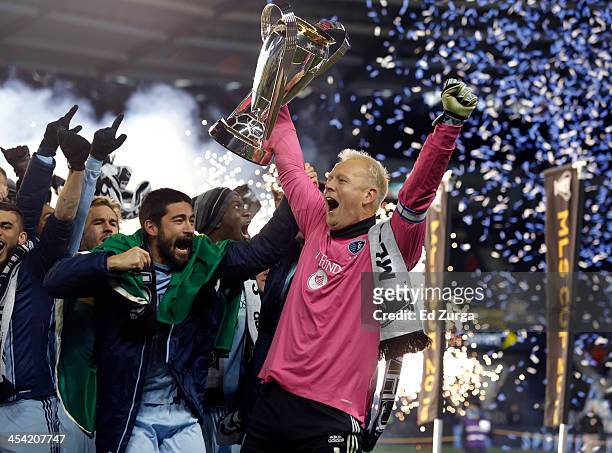 Paulo Nagamura and Jimmy Nielsen of Sporting Kansas City celebrate with the trophy after winning the MLS Cup Final against the Real Salt Lake at...