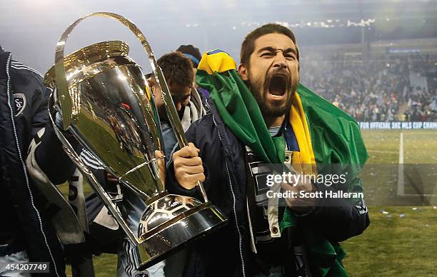 Paulo Nagamura of Sporting KC celebrates with the Philip F. Anschutz trophy after defeating Real Salt Lake in a shootout to win the 2013 MLS Cup at...