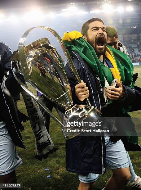 Paulo Nagamura of Sporting KC celebrates with the Philip F. Anschutz trophy after defeating Real Salt Lake in a shootout to win the 2013 MLS Cup at...