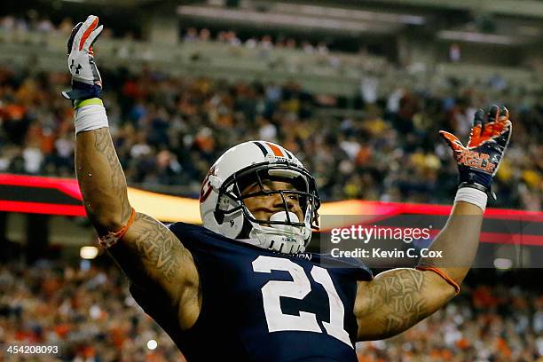 Tre Mason of the Auburn Tigers celebrates his fourth quarter touchdown against the Missouri Tigers during the SEC Championship Game at Georgia Dome...