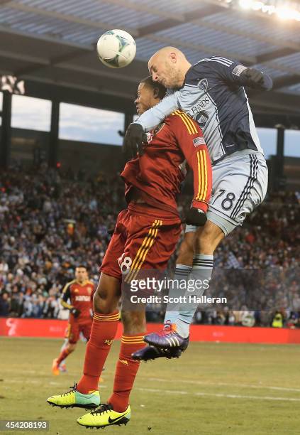 Aurelien Collin of Sporting KC leaps for the ball against Chris Schuler of Real Salt Lake in the second half of the 2013 MLS Cup at Sporting Park on...