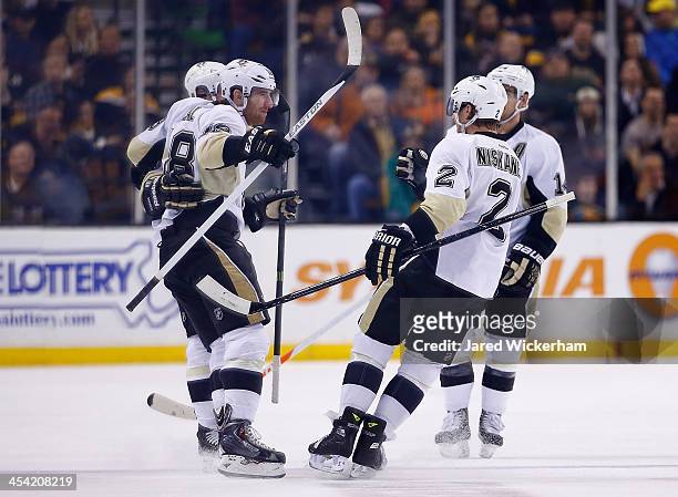 James Neal of the Pittsburgh Penguins celebrates his goal in the first period with teammates including Matt Niskanen against the Boston Bruins during...