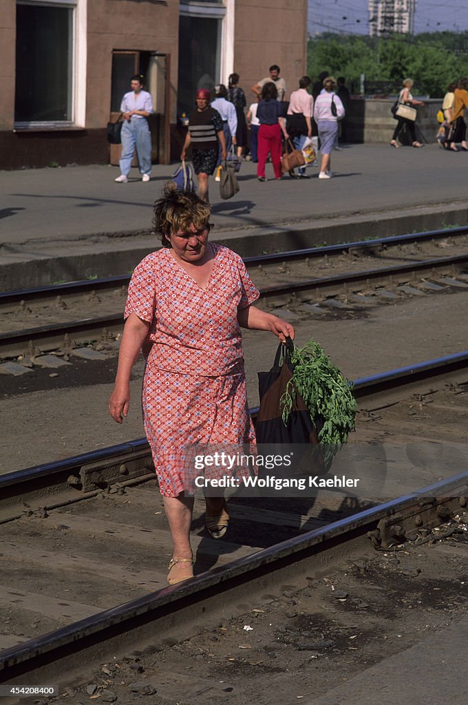 Russia, Perm Railway Station, Woman Crossing Tracks...