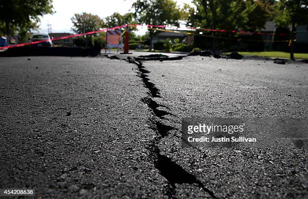 Crack runs down the center of an earthquake-damaged street on August 26, 2014 in Napa, California. Two days after a 6.0 earthquake rocked the Napa...