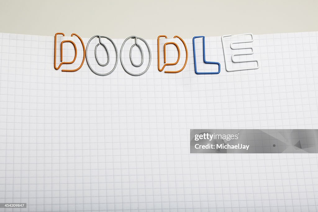 Doodle - Paper clip letters on notepad