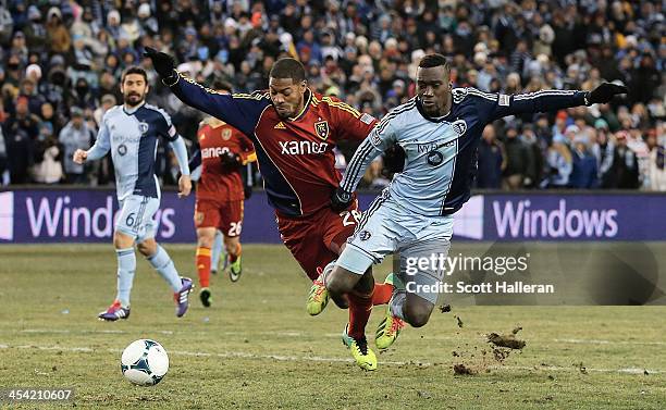 Sapong of Sporting KC fights for the ball against Chris Schuler of Real Salt Lake in the second half of the 2013 MLS Cup at Sporting Park on December...