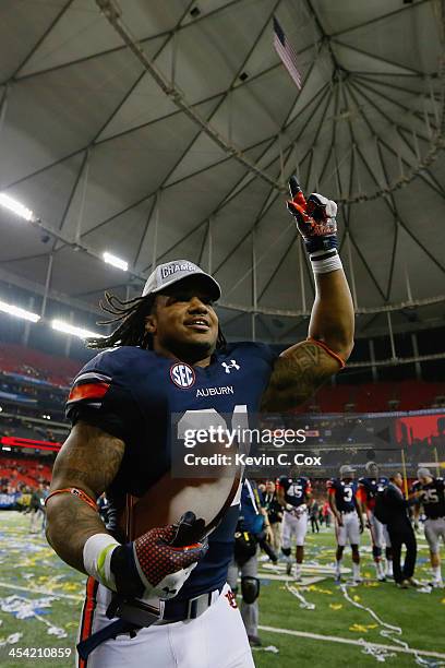 Tre Mason of the Auburn Tigers celebrates after defeating the Missouri Tigers 59-42 to win the SEC Championship Game at Georgia Dome on December 7,...
