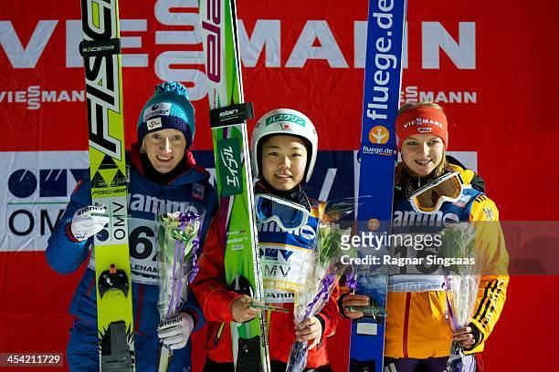 Daniela Iraschko-Stolz of Austria, Sara Takanashi of Japan and Gianina Ernst of Germany pose on the podium during the FIS Ski Jumping World Cup...