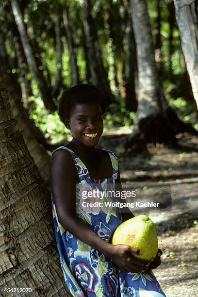 Solomon Islands, Rendova Lagoon, Lubaria Island, Native Girl Leaning On A Coconut Palm Trunk.