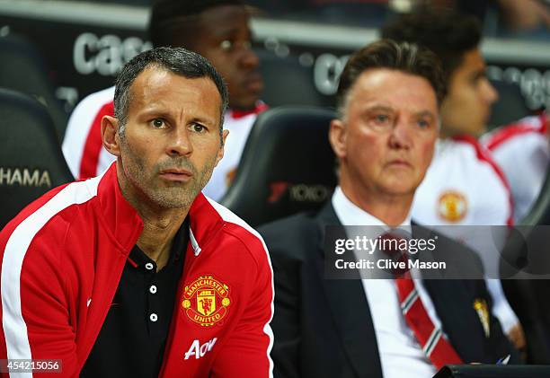Assistant manager Ryan Giggs looks on with manager Louis van Gaal of Manchester United prior to the Capital One Cup Second Round match between MK...
