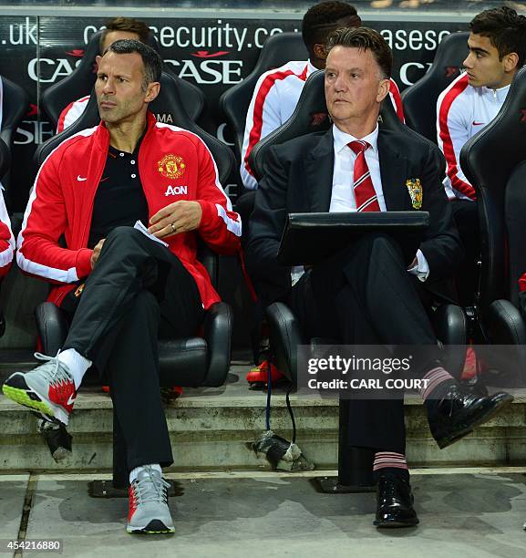 Manchester United's Welsh assistant manager Ryan Giggs and Manchester United's Dutch manager Louis van Gaal look on ahead of the English League Cup...