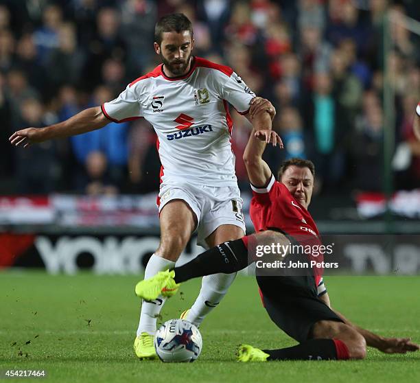 Jonny Evans of Manchester United in action with Will Grigg of MK Dons during the Capital One Cup Second Round match between MK Dons and Manchester...
