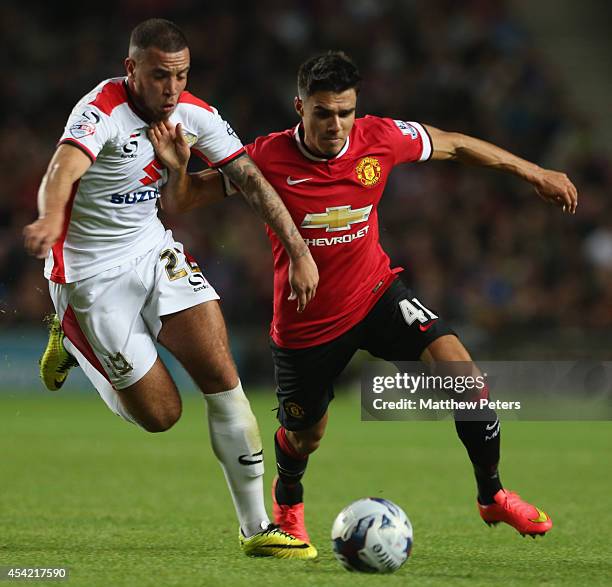 Reece James of Manchester United in action with Samir Carruthers of MK Dons during the Capital One Cup Second Round match between MK Dons and...