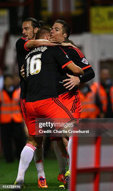 Ross McCormack of Fulham celebrates with team mates after scoring the first goal of the game during the Capital One Cup Second Round match between...