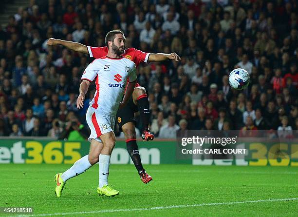 Dons Northern Irish striker Will Grigg scores their second goal during the English League Cup second round football match between Milton Keynes Dons...