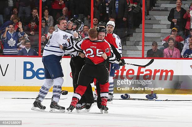 Frazer McLaren of the Toronto Maple Leafs has words with Chris Neil of the Ottawa Senators after their fight at Canadian Tire Centre on December 7,...
