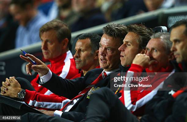 Manager Louis van Gaal of Manchester United gives instructions with assistant Ryan Giggs during the Capital One Cup Second Round match between MK...