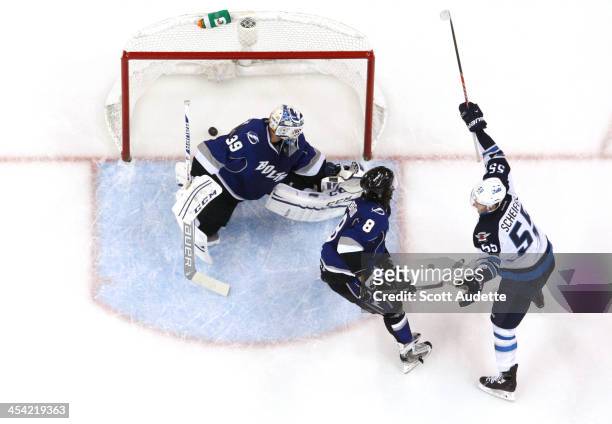 Mark Scheifele of the Winnipeg Jets celebrates his game-winning goal against goalie Anders Lindback and Mark Barberio of the Tampa Bay Lightning...