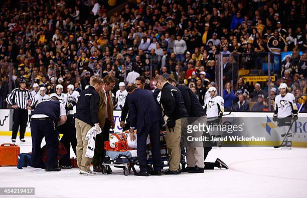Brooks Orpik of the Pittsburgh Penguins is carted off of the ice on a stretcher by the medical staff in the first period after an altercation with...