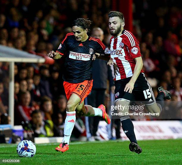 Kay Voser of Fulham looks to get past Brentford's Stuart Dallas during the Capital One Cup Second Round match between Brentford and Fulham at Griffin...