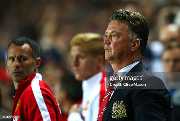 Manager Louis van Gaal of Manchester United looks dejected with assistant Ryan Giggs after the Capital One Cup Second Round match between MK Dons and...