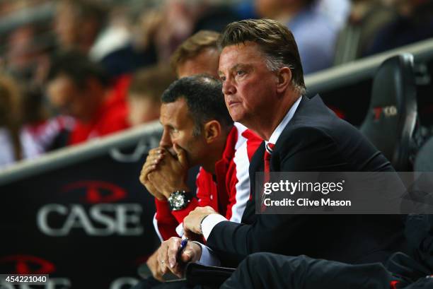 Manager Louis van Gaal of Manchester United looks dejected with assistant Ryan Giggs during the Capital One Cup Second Round match between MK Dons...