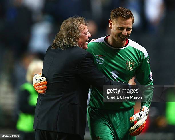 David Martin of Milton Keynes Dons is congratulated by chairman Pete Winkleman after the Capital One Cup Second Round match between MK Dons and...