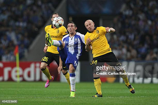 Porto's midfielder Hector Herrera tries to escape Lille's midfielder Florent Balmont during the football match between FC Porto and LOSC Lille at...