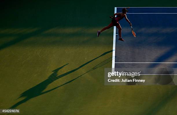 Nicole Gibbs of the United States serves against Caroline Garcia of France during their women's singles first round match on Day Two of the 2014 US...