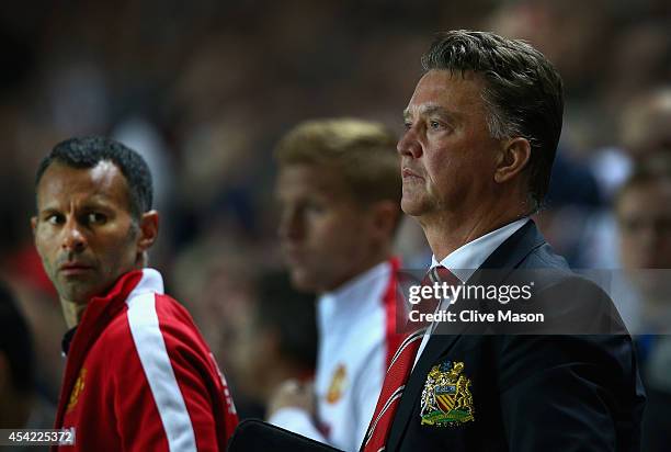Manager Louis van Gaal of Manchester United looks dejected with assistant Ryan Giggs after the Capital One Cup second round match between MK Dons and...
