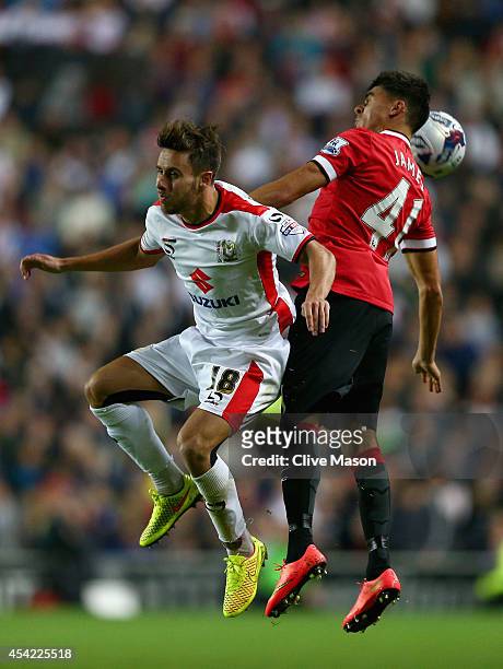 George Baldock of MK Dons in action against Reece James of Manchester United during the Capital One Cup second round match between MK Dons and...