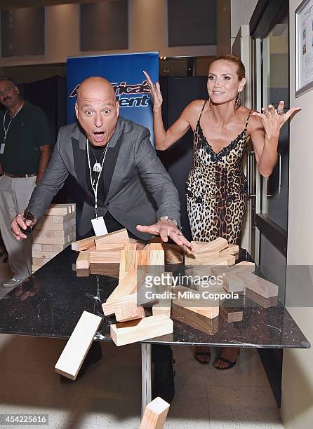 Comedian/television personality Howie Mandel and model/television personalty Heidi Klum knock down a Jenga puzzle at the "America's Got Talent"...