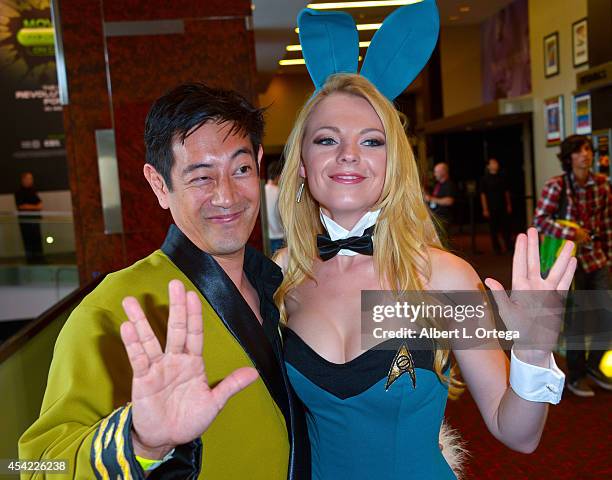 Personality Grant Imahara and cosplayer Jennifer Newman dressed as a Star Trek Bunny posing for photos at the Hard Rock Hotel on Friday Day 2 of...