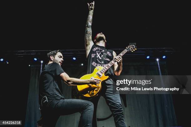 Jeremy McKinnon and Kevin Skaff of A Day To Remember perform on stage at Motorpoint Arena on August 26, 2014 in Cardiff, United Kingdom.