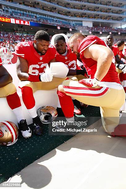 Tony Jerod-Eddie, Demarcus Dobbs and Dan Skuta of the San Francisco 49ers study formations during the game against the San Diego Chargers at Levi...