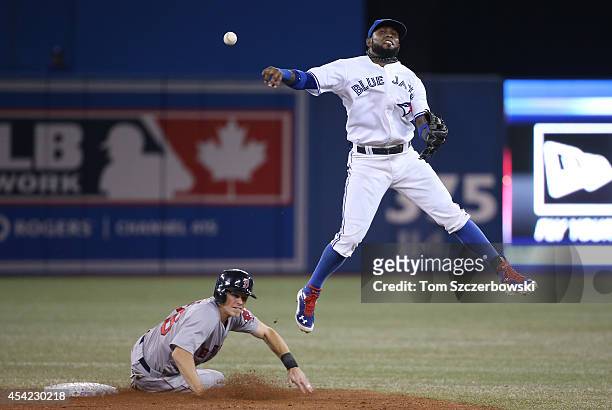 Jose Reyes of the Toronto Blue Jays forces out the lead runner but cannot turn the double play in the ninth inning during MLB game action as Brock...