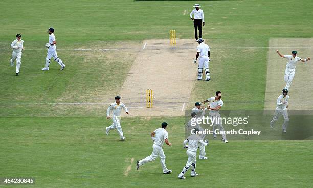 Mitchell Johnson of Australia celebrates with teammates after dismissing England captain Alastair Cook during day four of the Second Ashes Test Match...