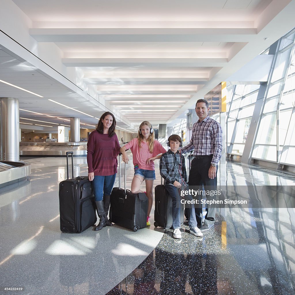 Portrait of family at airport between flights