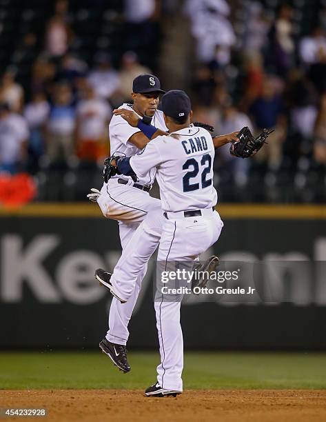 Endy Chavez of the Seattle Mariners celebrates with Robinson Cano after defeating the Texas Rangers 5-0 at Safeco Field on August 26, 2014 in...