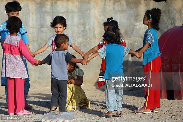 Displaced Iraqi children who fled Wadi Osaj village near Jalawla as battles between peshmerga and Islamic State jihadists broke out play as they take...