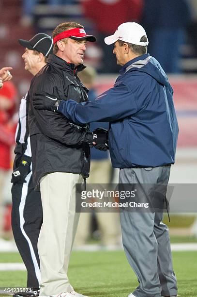 Head coach Mark Hudspeth of the Louisiana-Lafayette Ragin Cajuns shake hands with head coach Joey Jones of the South Alabama Jaguars on December 7,...