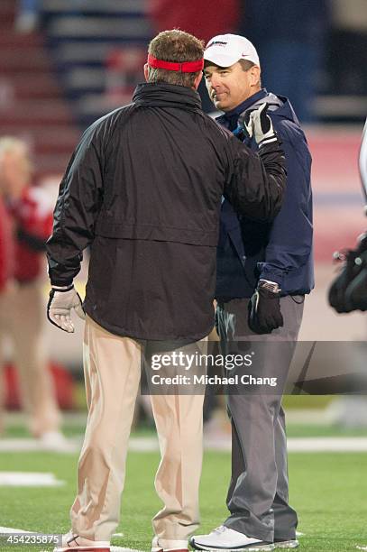 Head coach Mark Hudspeth of the Louisiana-Lafayette Ragin Cajuns shake hands with head coach Joey Jones of the South Alabama Jaguars on December 7,...