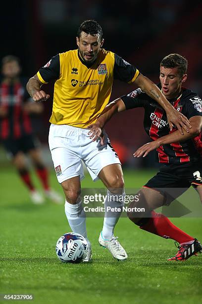 Marc Richards of Northampton Town controls the ball under pressure from Baily Cargill of AFC Bournemouth during the Capital One Cup Second Round...