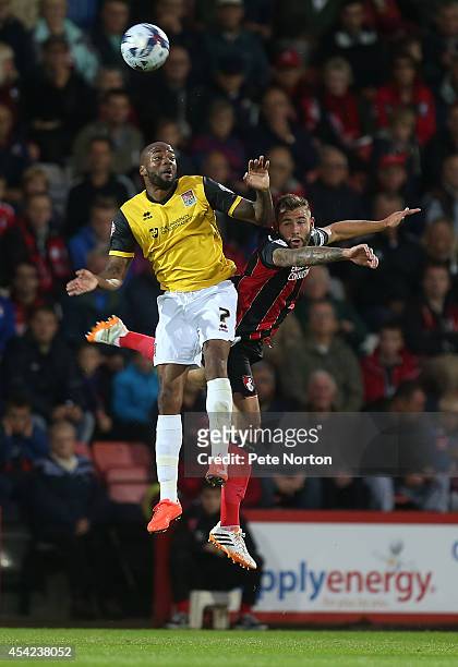 Emile Sinclair of Northampton Town challenges for the ball with Steve Cook of AFC Bournemouth during the Capital One Cup Second Round match between...