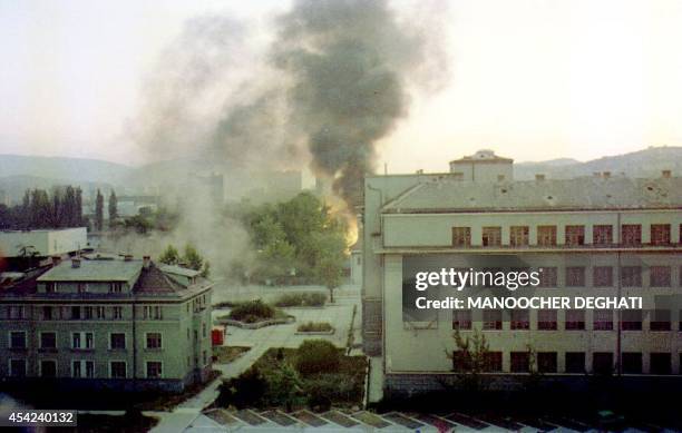 This photo shows part of the Marshal Tito Military Base burning after Serbian forces shelled Sarajevo 20 August 1992. Eight U.N. Trucks were...
