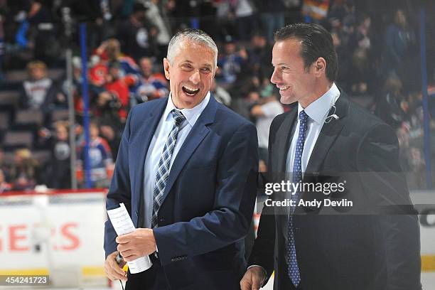Bob Hartley and Martin Gelinas of the Calgary Flames leave the bench following a win against the Edmonton Oilers on December 7, 2013 at Rexall Place...