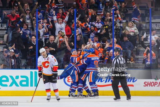 Ales Hemsky, David Perron, Taylor Hall, and Ryan Nugent-Hopkins of the Edmonton Oilers celebrate the game-tying goal by Taylor Hall to force overtime...
