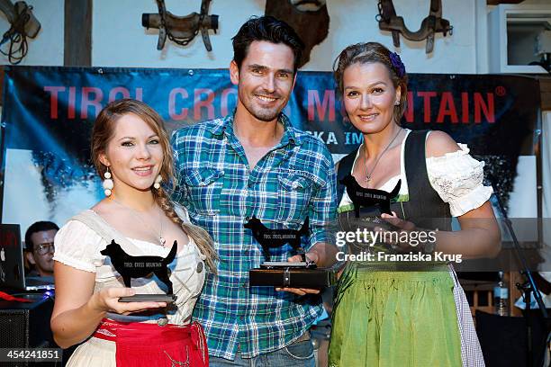 Sophie Moser, Jan Kralitschka and Franziska van Almsick receive an award at the Dorfstadl Evening - Tirol Cross Mountain 2013 on December 07, 2013 in...