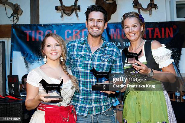 Sophie Moser, Jan Kralitschka and Franziska van Almsick receive an award at the Dorfstadl Evening - Tirol Cross Mountain 2013 on December 07, 2013 in...